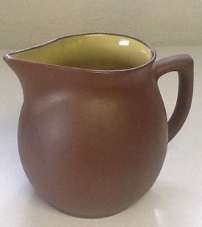 PIGEON FORGE POTTERY   TENN   5.25 PITCHER brown outiside/yello​w 