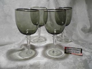 Smokey grey color wine glass with silver rims and clear stem and base 