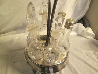 Silver plate 7 piece caster set. All stoppers are glass. Rogers Smith 