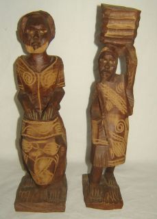 pair of hand carved wood african man and women figurines