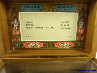 This exquisite wooden music box made by Reuge Music of Sainte Croix 