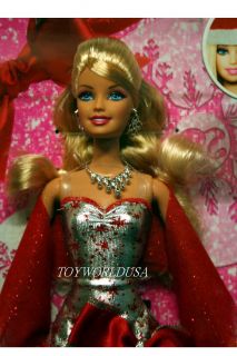 Dressed in red and silver gown with big red bow on side of waist Doll